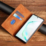 Leather wallet-style phone case with card slots and a smartphone partially inserted.