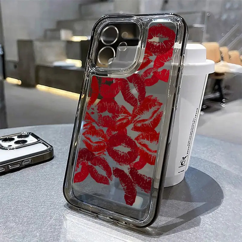 a red and white phone case sitting on a table