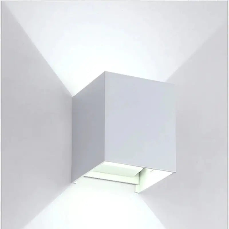 a white wall light with a square shape