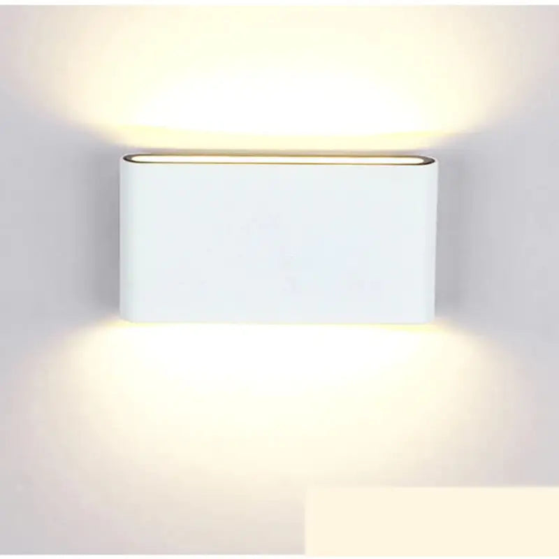 a white wall light with a square shape