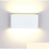 a white wall light with a square shape