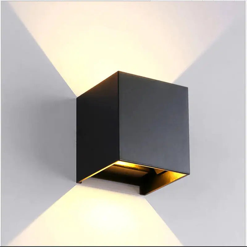 a black wall light with a white light