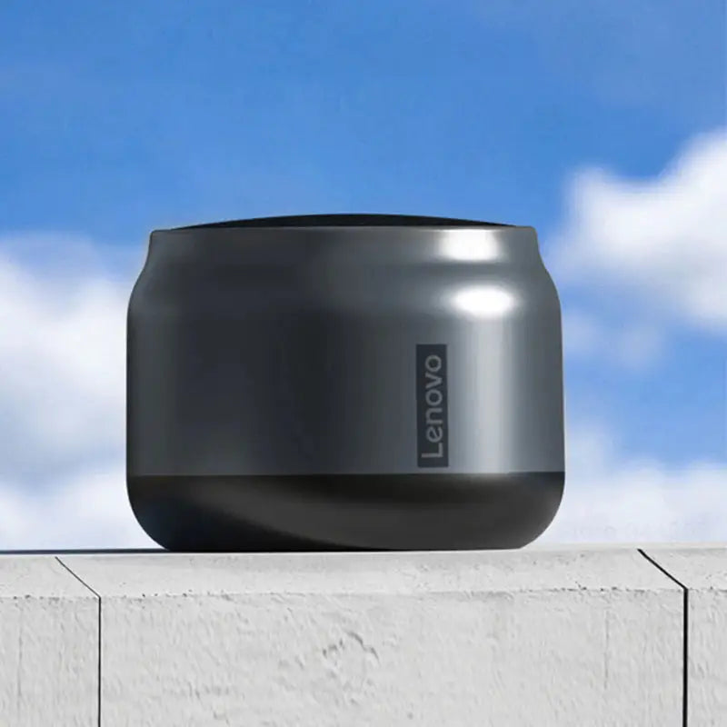 a black speaker sitting on top of a white wall