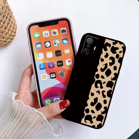 a woman holding a phone case with a leopard print