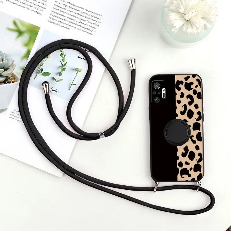 a black and white phone case with a black strap