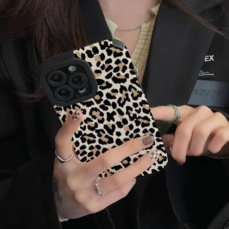 a woman holding a cell phone case