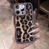 Leopard print phone case adorned with rhinestones.