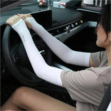 a woman in a car with white arm sleeves