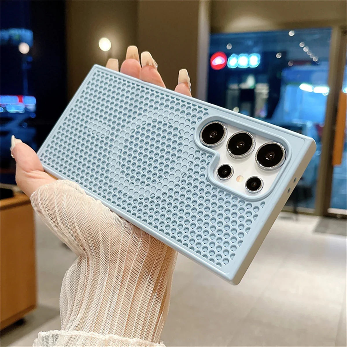 Light blue perforated smartphone case with multiple camera cutouts.