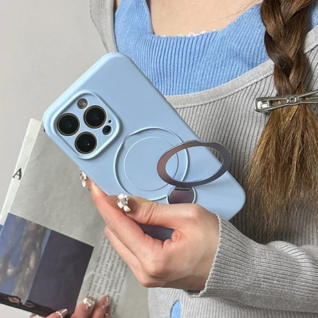 Light blue phone case with a circular magnetic stand and ring holder.