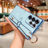 Light blue phone case with a heart-shaped hand strap and a circular ring holder.