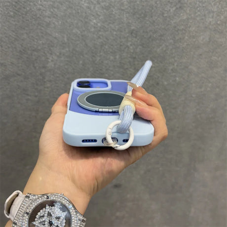 Light blue and purple phone case with a gray magnetic ring holder and a detachable light blue wrist strap.