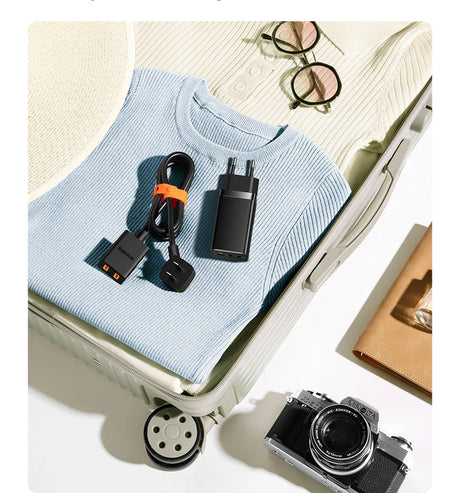 Light blue sweater or pullover placed on an open suitcase.