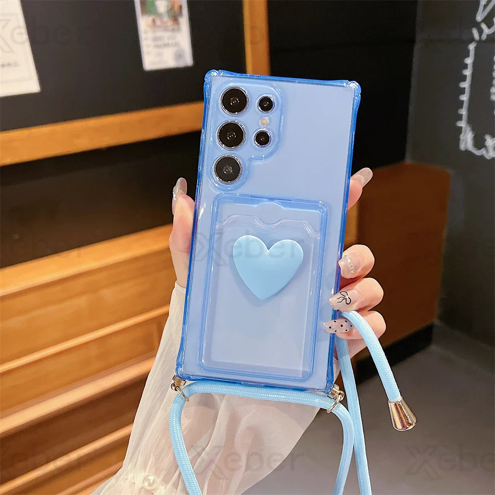 Light blue transparent phone case with a heart-shaped card holder and a matching lanyard.