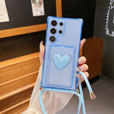 Light blue transparent phone case with a heart-shaped card holder and a matching lanyard.