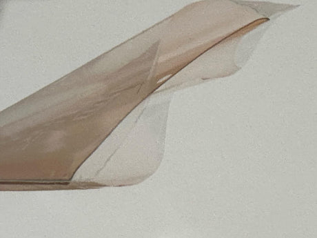 A light brown, translucent, flexible plastic sheet, possibly for packaging or crafting.