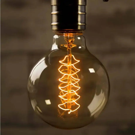 A light bulb with a christmas tree inside