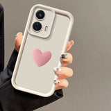 A light-colored smartphone with a heart-shaped design on the back.