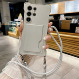 Light gray phone case with a built-in card holder and an attached lanyard.