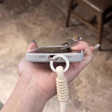 A light gray phone case with a white lanyard attached.