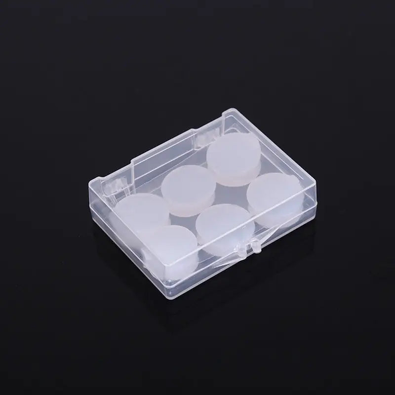 a clear plastic box with four white circles inside