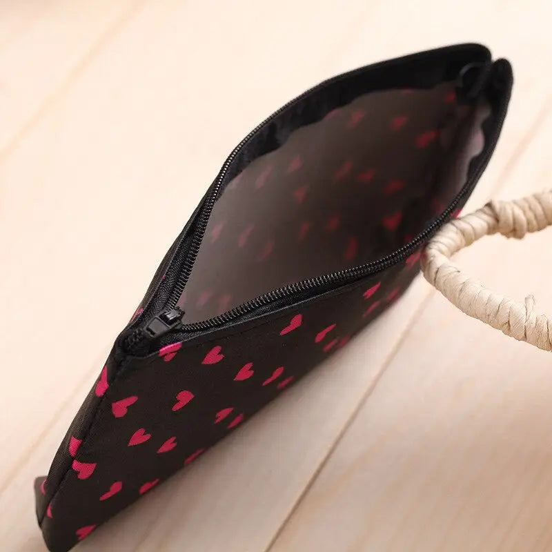 a black and pink heart print purse bag