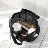 a black bag with makeup products inside