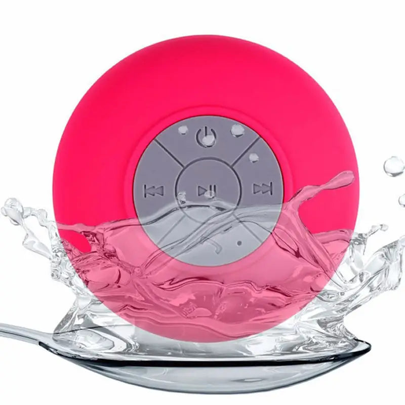 a pink waterproof speaker with a splash of water