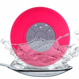 a pink waterproof speaker with a splash of water