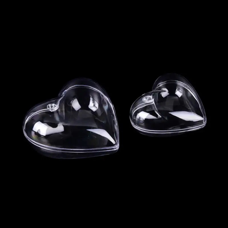 two clear heart shaped glass paperweights