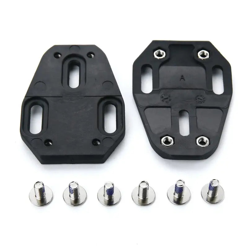 a pair of black plastic pedals with screws