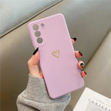 Lilac phone case with a gold heart design.
