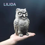 a hand holding a small owl fig