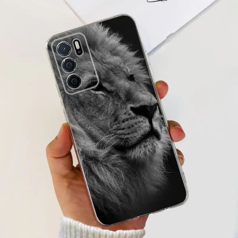 a hand holding a black and white lion phone case