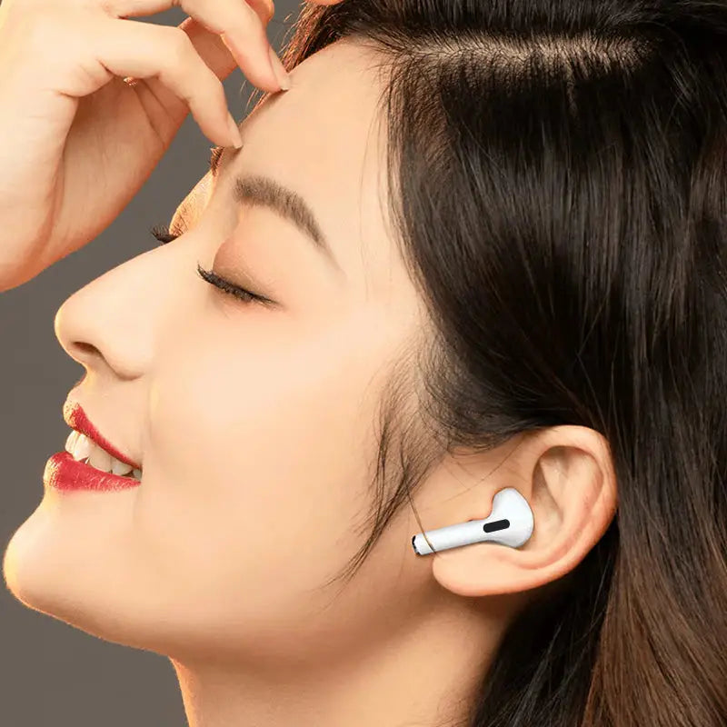 a woman wearing a pair of bluetooth earphones