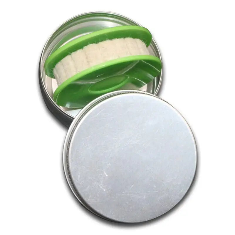 a tin with a green lid and a white container