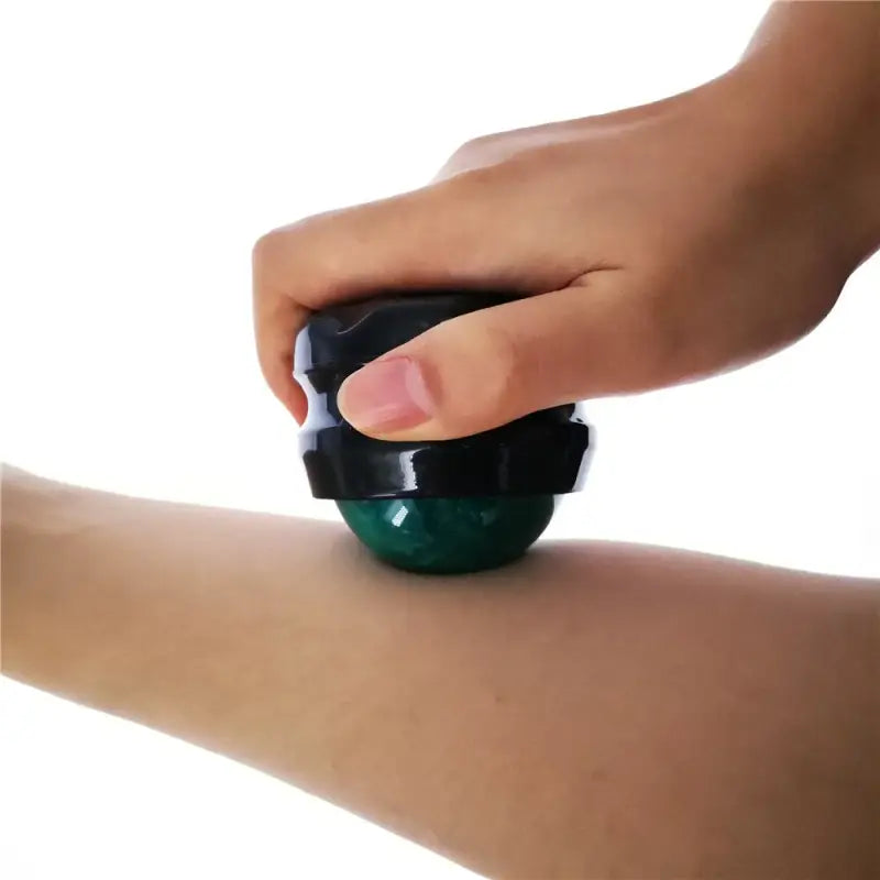 a person is using a green ball to remove the skin