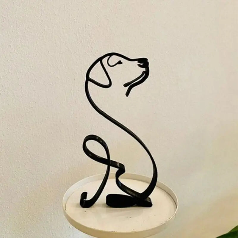 a metal cat sculpture on a white pedestal