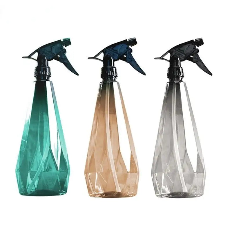 three different colored spray bottles with a sprayer