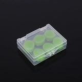 a clear plastic box with green plastic discs inside