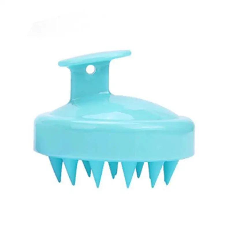 a blue plastic brush with spikes on it