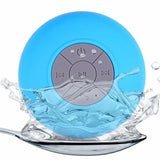 a blue waterproof speaker with a splash of water