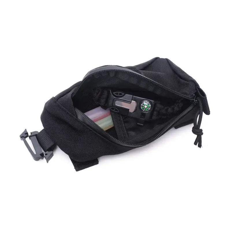 the back of a black fanny bag with a small camera inside