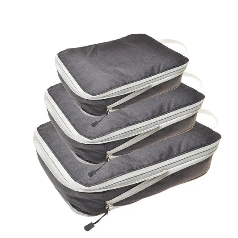 three grey bags with zippers on them