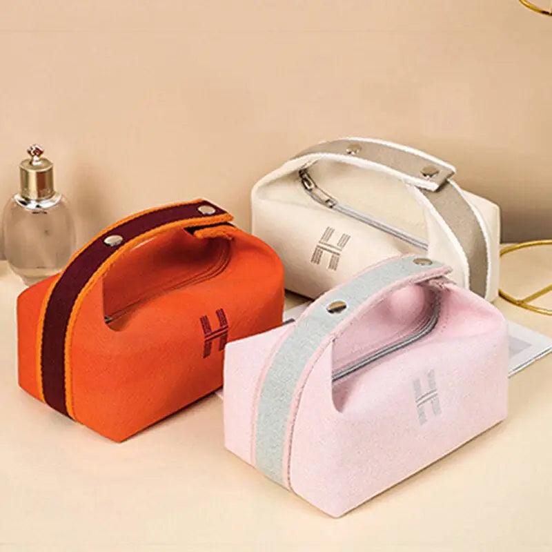 three small cosmetic bags with zipper closure