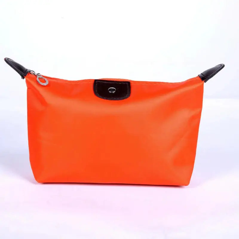 a bright orange cosmetic bag with black handles