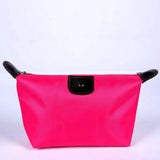 a pink cosmetic bag with black handles