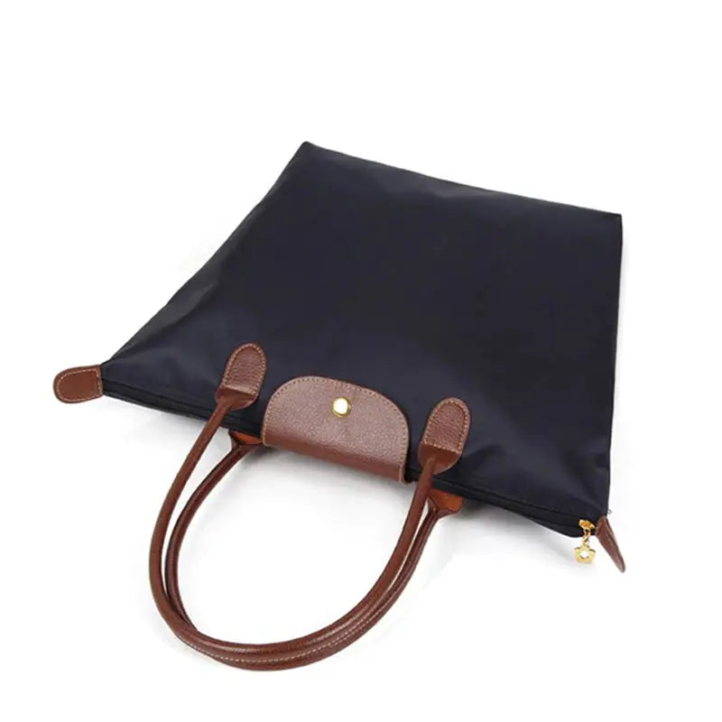 the black leather backpack with brown leather handles
