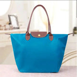 a blue bag with brown handles and handles