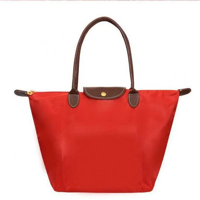 a red tote bag with brown handles